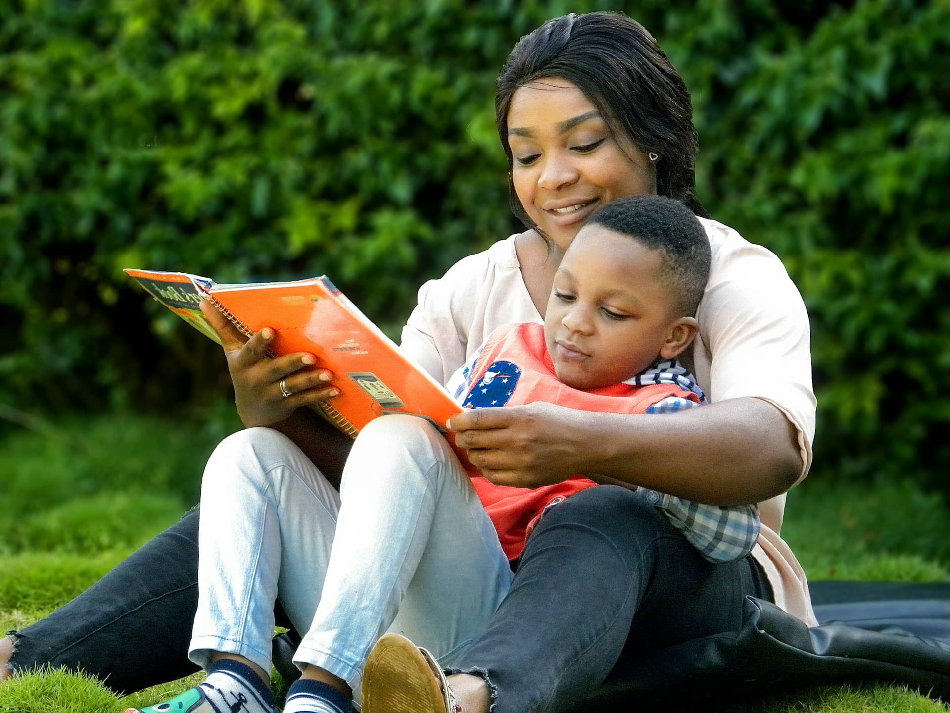 A parent and child reading a picture book together